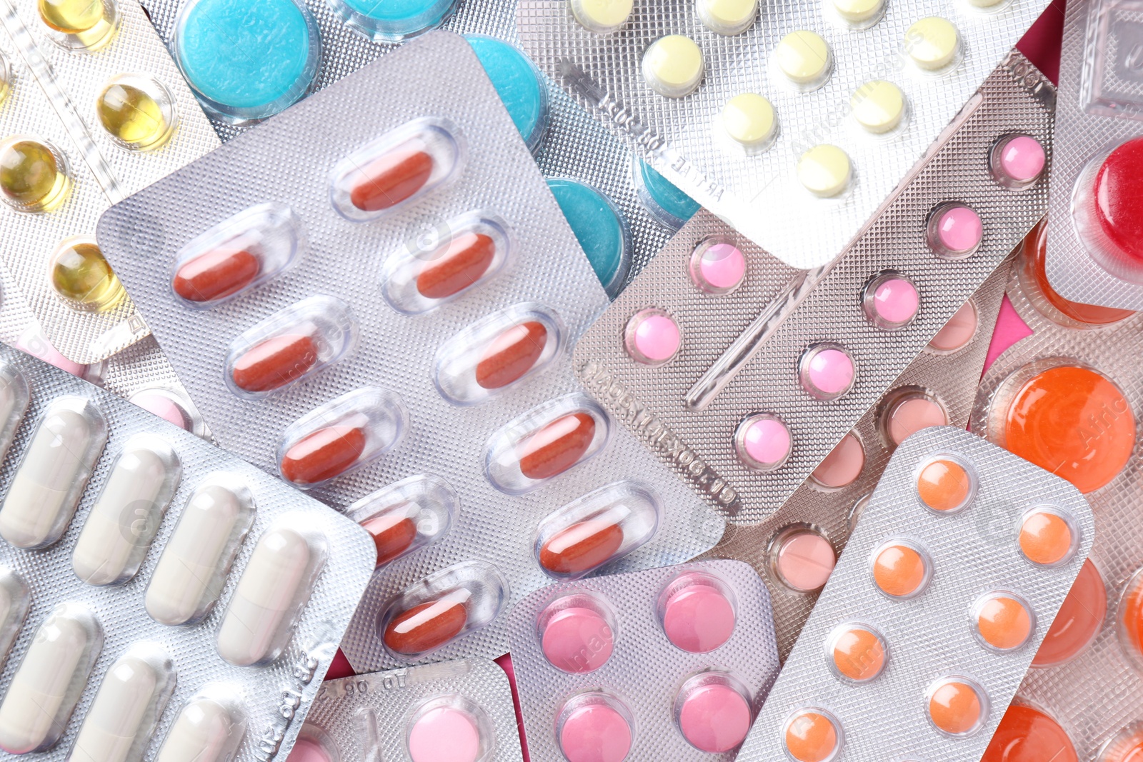 Photo of Pharmacist concept. Flat lay composition with many different pills on pink background