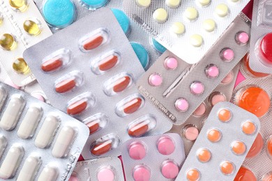 Photo of Pharmacist concept. Flat lay composition with many different pills on pink background