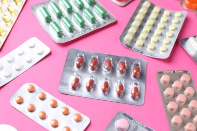 Photo of Pharmacist concept. Many different pills on pink background