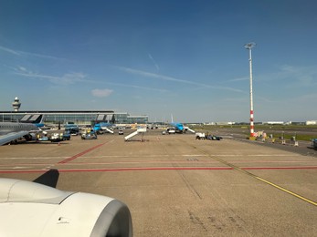 Haarlemmermeer, Netherlands - July 30, 2024: Modern airplanes in Amsterdam Airport Schiphol, view through plane window