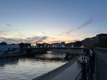 Photo of Berlin, Germany - July 30, 2024: Picturesque view of buildings and bridge over Spree river at sunset