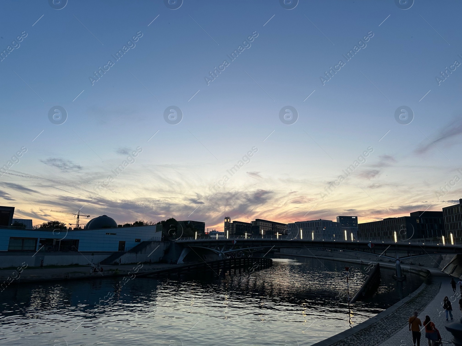 Photo of Berlin, Germany - July 30, 2024: Picturesque view of buildings and bridge over Spree river at sunset