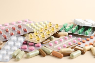 Pharmacist. Many different pills on beige background, closeup