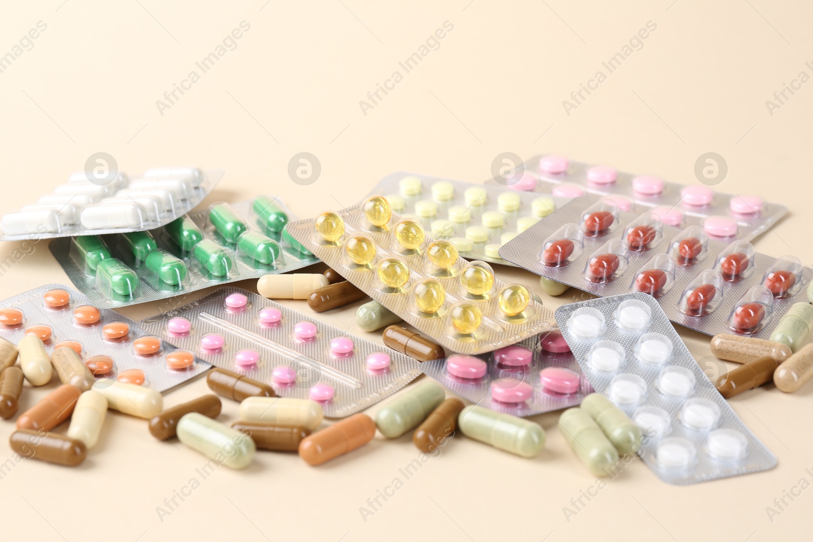 Photo of Pharmacist. Many different pills on beige background