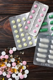 Pharmacist. Many different pills on wooden table, flat lay