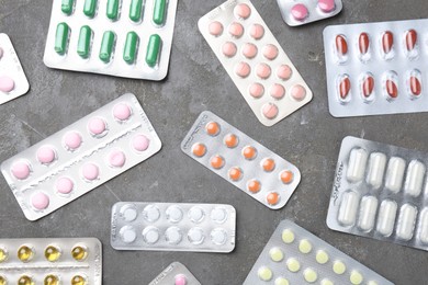 Pharmacist. Many different pills on grey table, flat lay