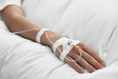 Photo of Coma patient. Man with intravenous drip in hospital bed, closeup