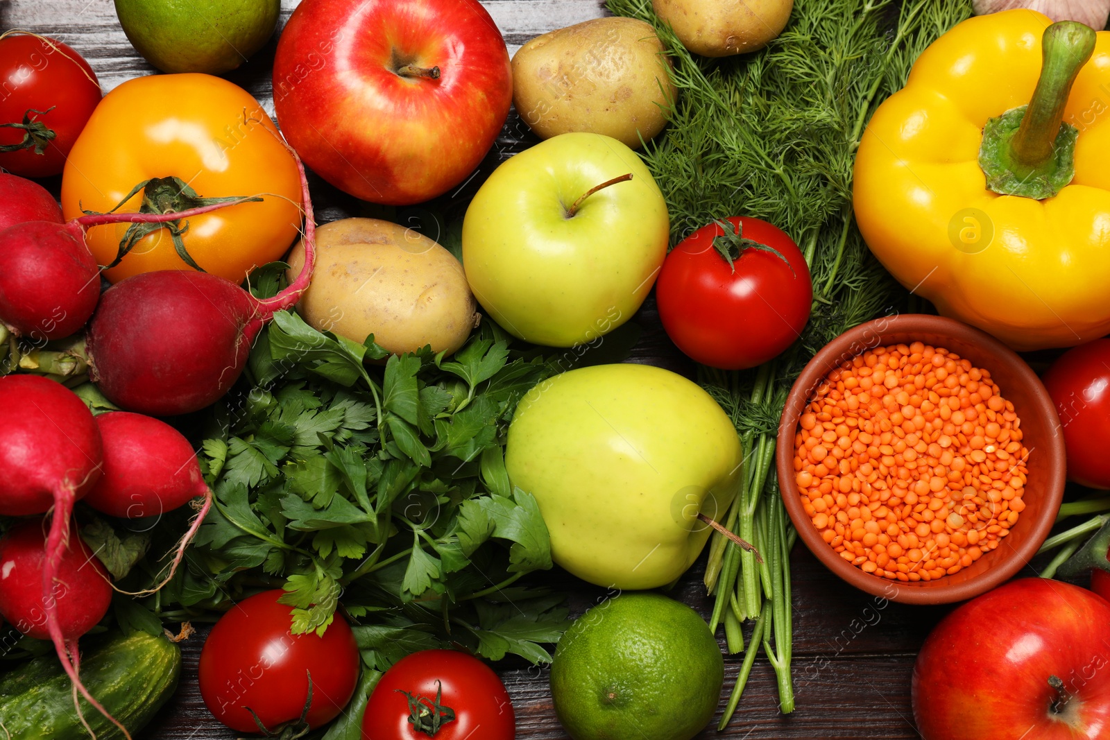 Photo of Different vegetarian products on wooden table, top view