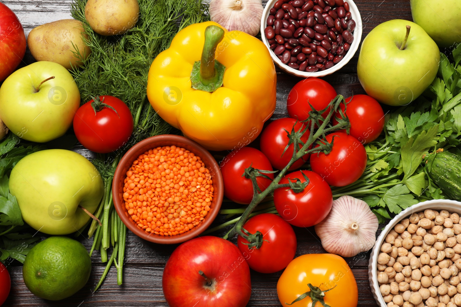 Photo of Different vegetarian products on wooden table, top view