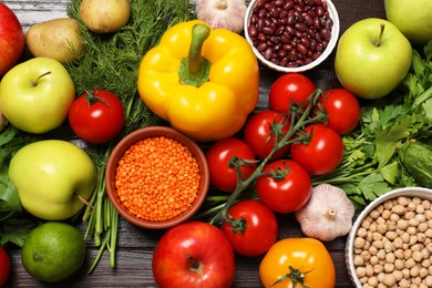 Photo of Different vegetarian products on wooden table, top view