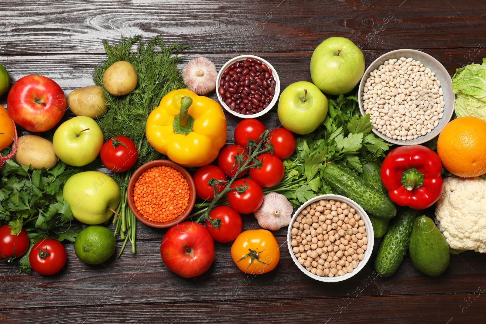 Photo of Different vegetarian products on wooden table, top view