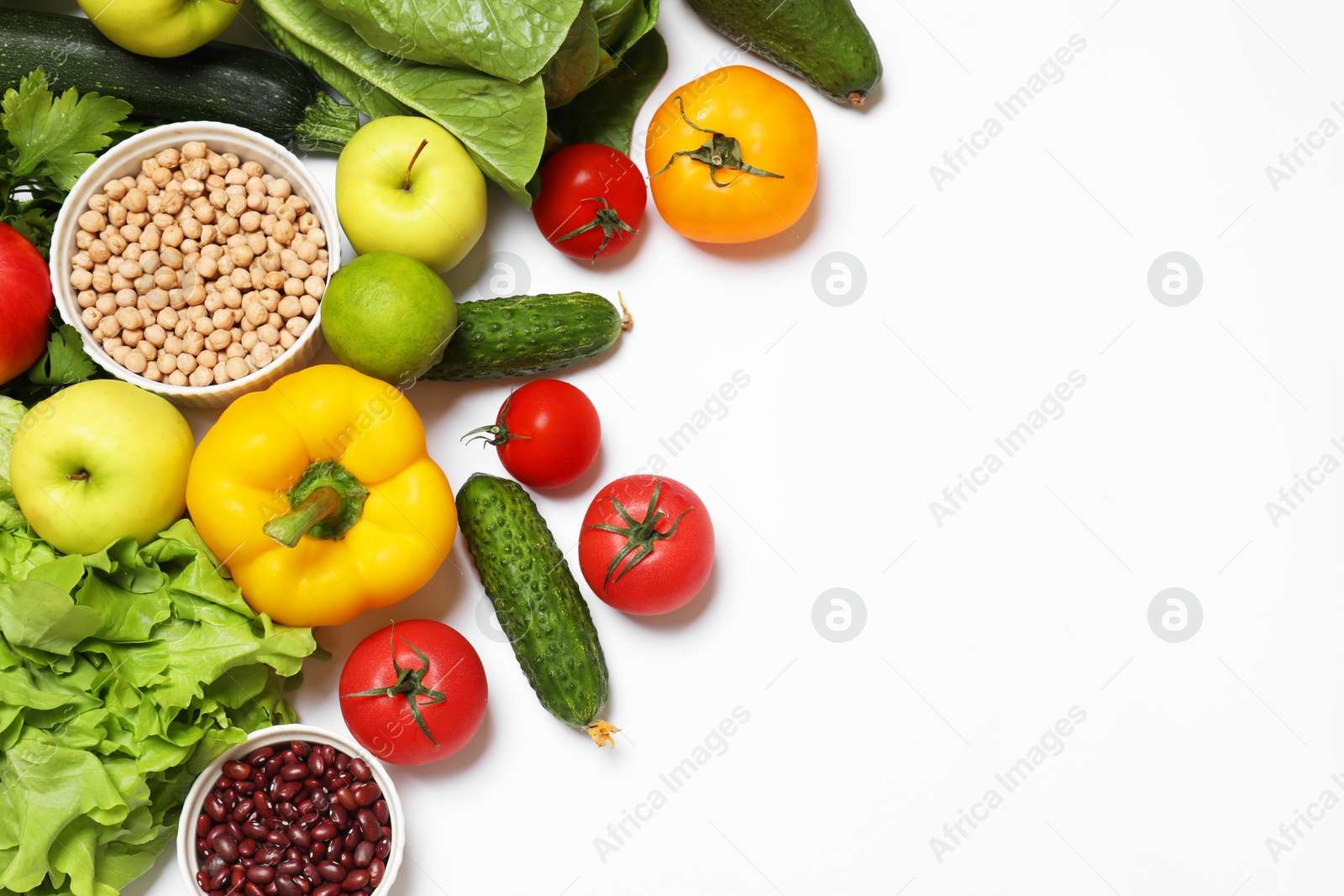 Photo of Healthy vegetarian food. Different vegetables, lentils and fruits on white background, flat lay. Space for text