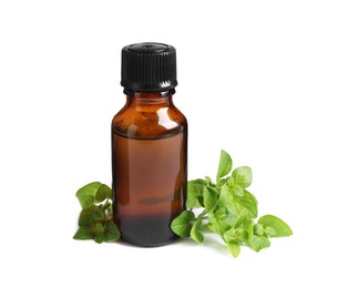 Photo of Essential oil in bottle and oregano leaves isolated on white