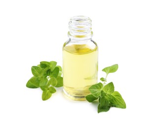 Photo of Essential oil in bottle and oregano leaves isolated on white