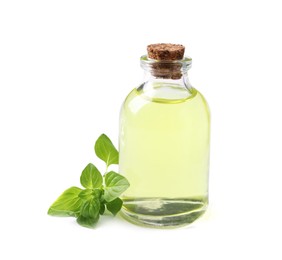 Photo of Essential oil in bottle and oregano leaves isolated on white