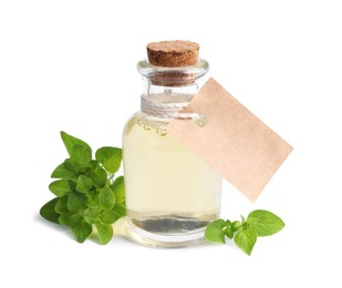 Essential oil in bottle with empty tag and oregano leaves isolated on white