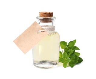 Photo of Essential oil in bottle with empty tag and oregano leaves isolated on white