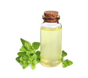 Photo of Essential oil in bottle and oregano leaves isolated on white