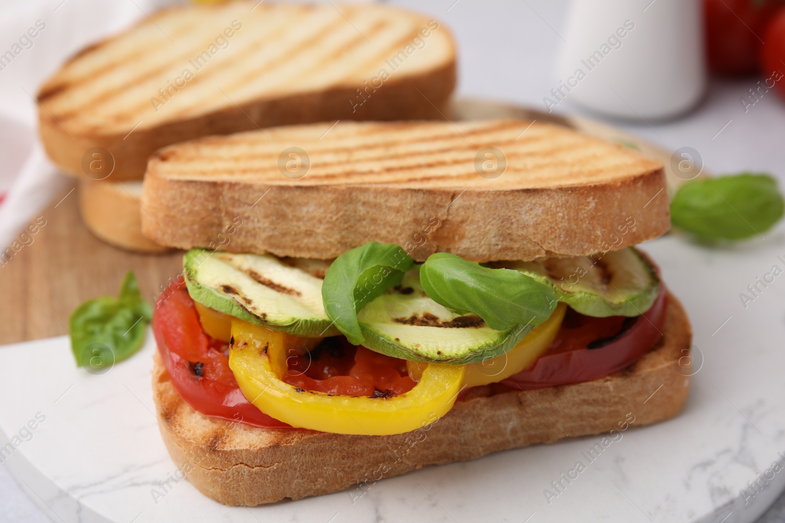 Photo of Tasty sandwiches with grilled vegetables on table, closeup