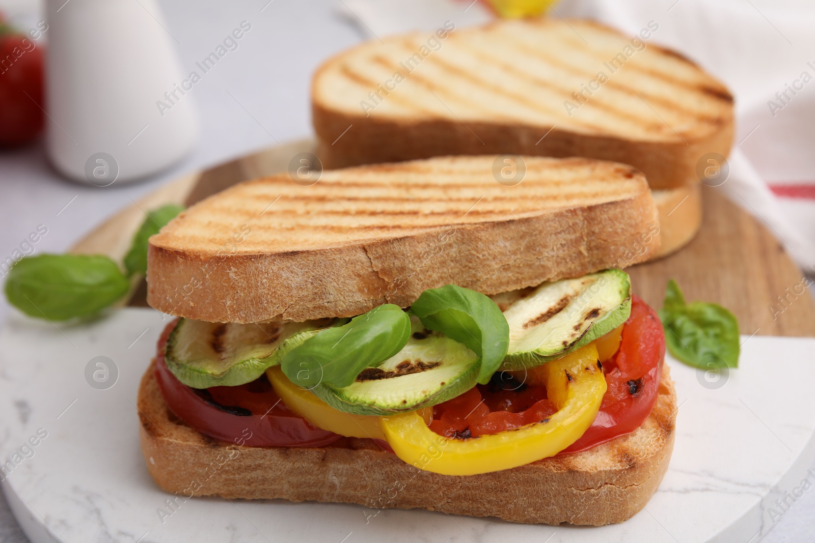 Photo of Tasty sandwiches with grilled vegetables on table, closeup