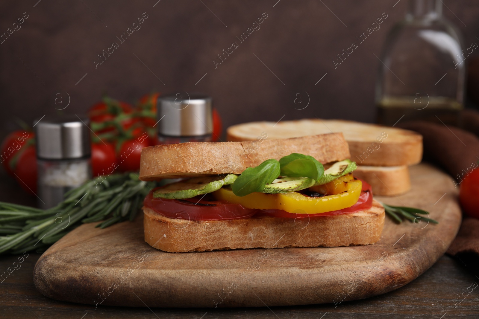 Photo of Tasty sandwich with grilled vegetables on wooden table, closeup