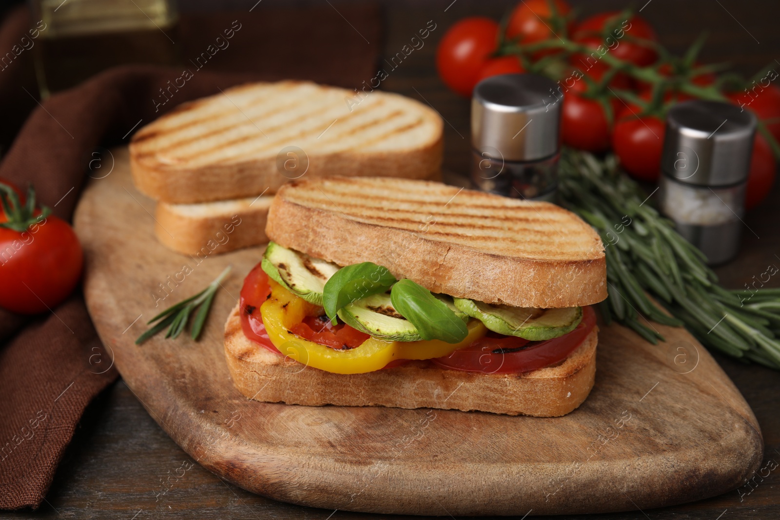 Photo of Tasty sandwiches with grilled vegetables on wooden table, closeup