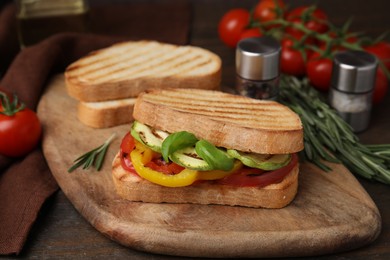 Photo of Tasty sandwiches with grilled vegetables on wooden table, closeup