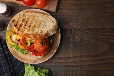 Photo of Tasty sandwich with grilled vegetables on wooden table, flat lay. Space for text