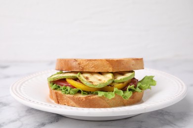 Photo of Tasty sandwich with grilled vegetables on white marble table, closeup