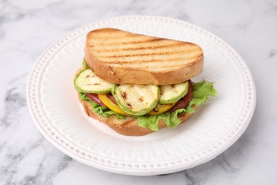 Photo of Tasty sandwich with grilled vegetables on white marble table, closeup