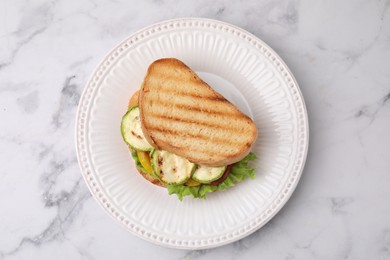 Photo of Tasty sandwich with grilled vegetables on white marble table, top view