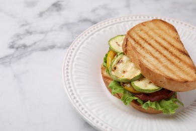 Photo of Tasty sandwich with grilled vegetables on white marble table, closeup. Space for text