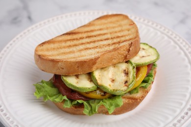 Photo of Tasty sandwich with grilled vegetables on plate, closeup