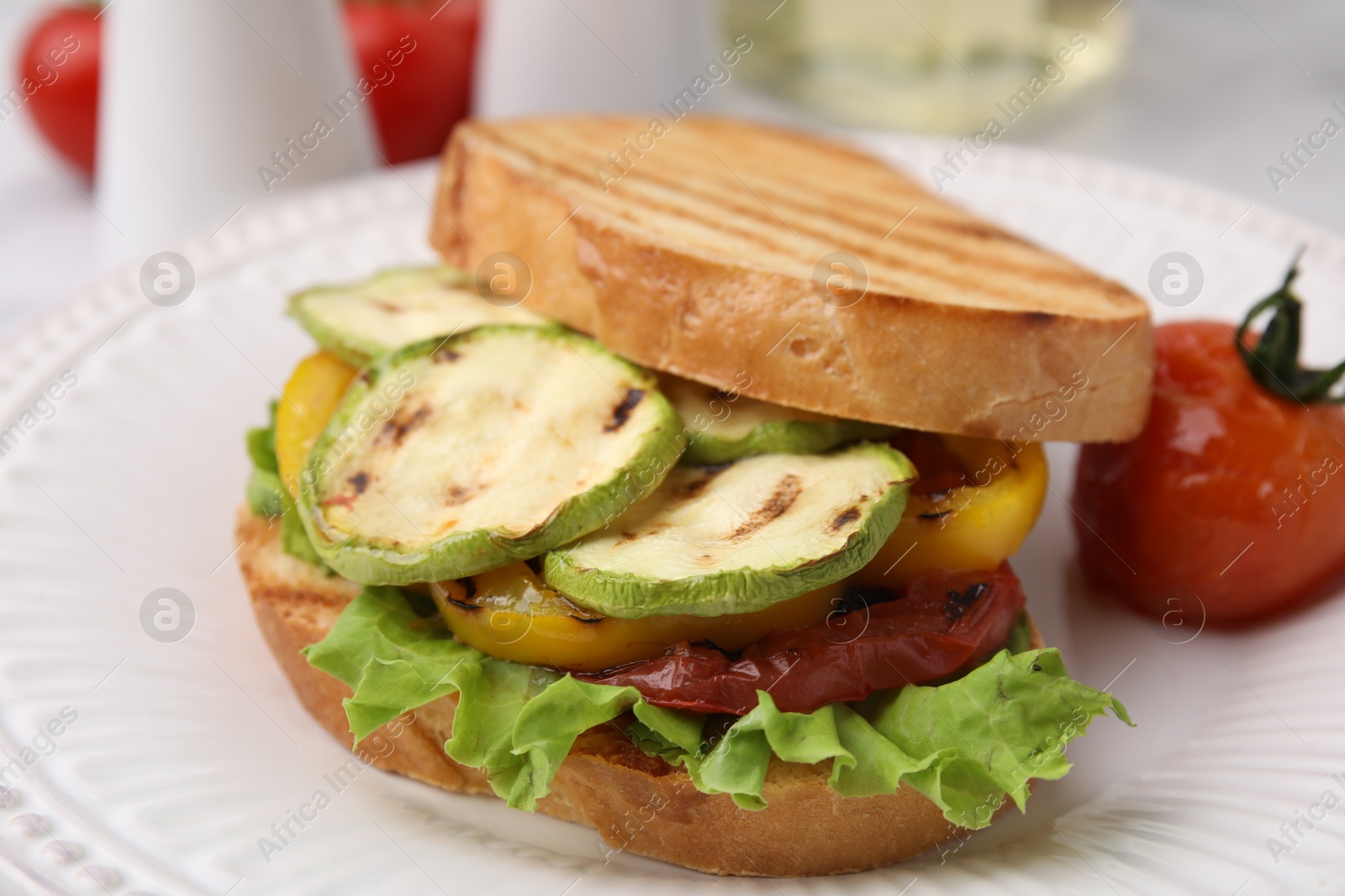 Photo of Tasty sandwich with grilled vegetables on table, closeup