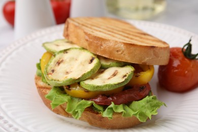 Photo of Tasty sandwich with grilled vegetables on table, closeup