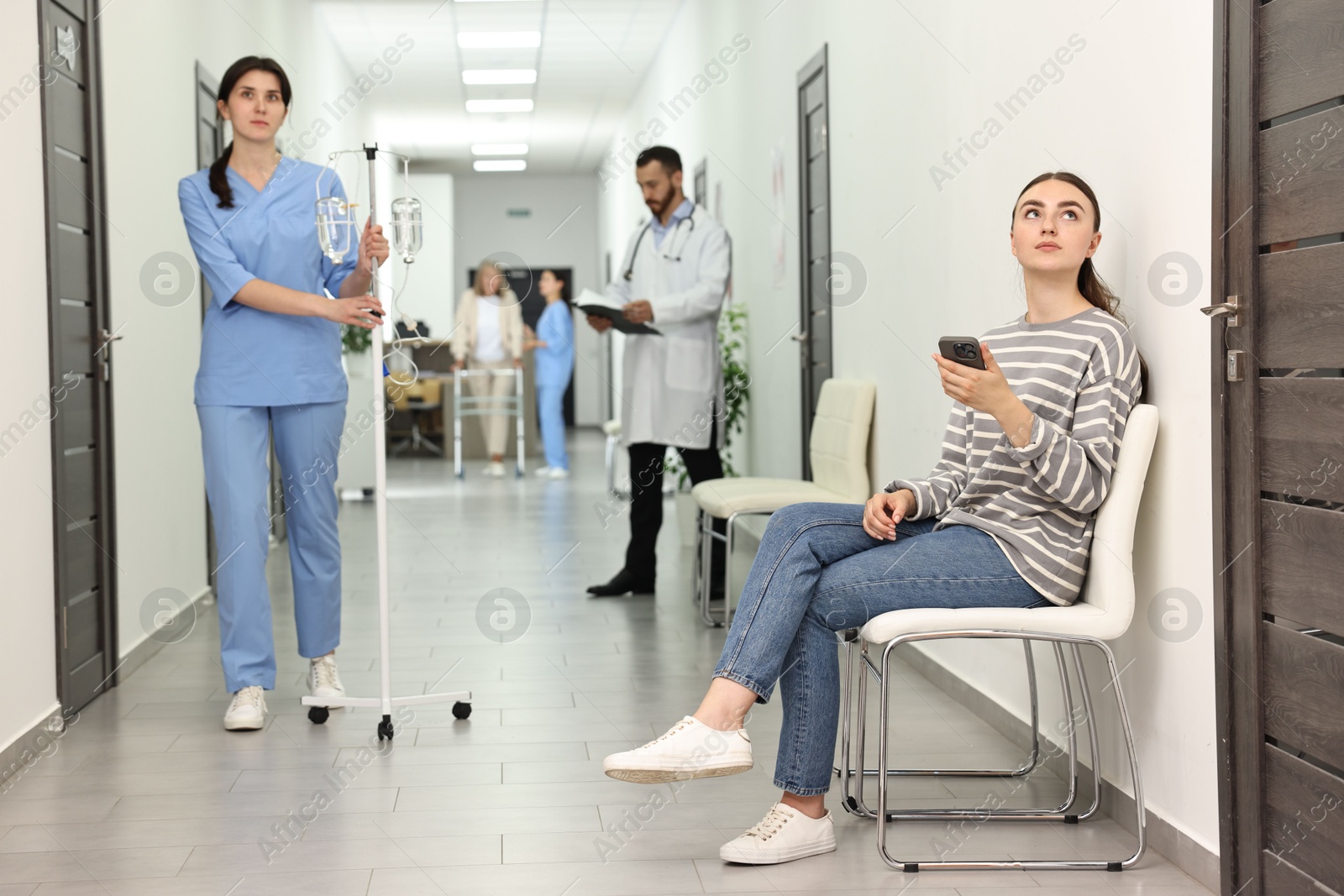 Photo of Patients and doctors in hospital hallway, selective focus