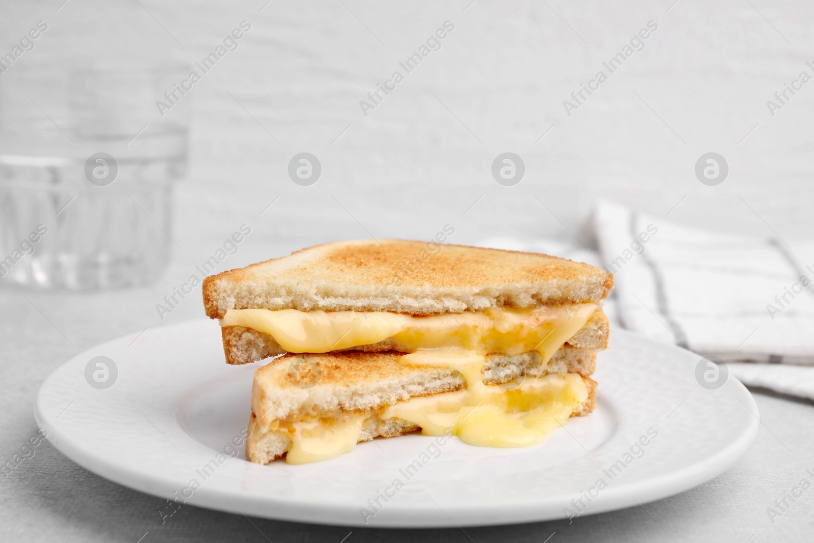 Photo of Pieces of toasted bread with melted cheese on light table