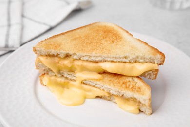 Photo of Pieces of toasted bread with melted cheese on table, closeup