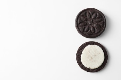 Photo of Halves of tasty sandwich cookie on white background, top view. Space for text