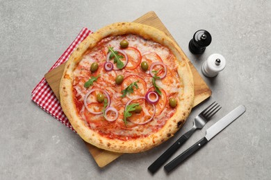 Photo of Delicious vegetarian pizza, cutlery, salt and pepper on light grey background, top view