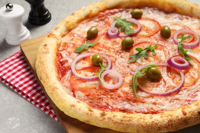 Photo of Delicious vegetarian pizza on light grey background, closeup