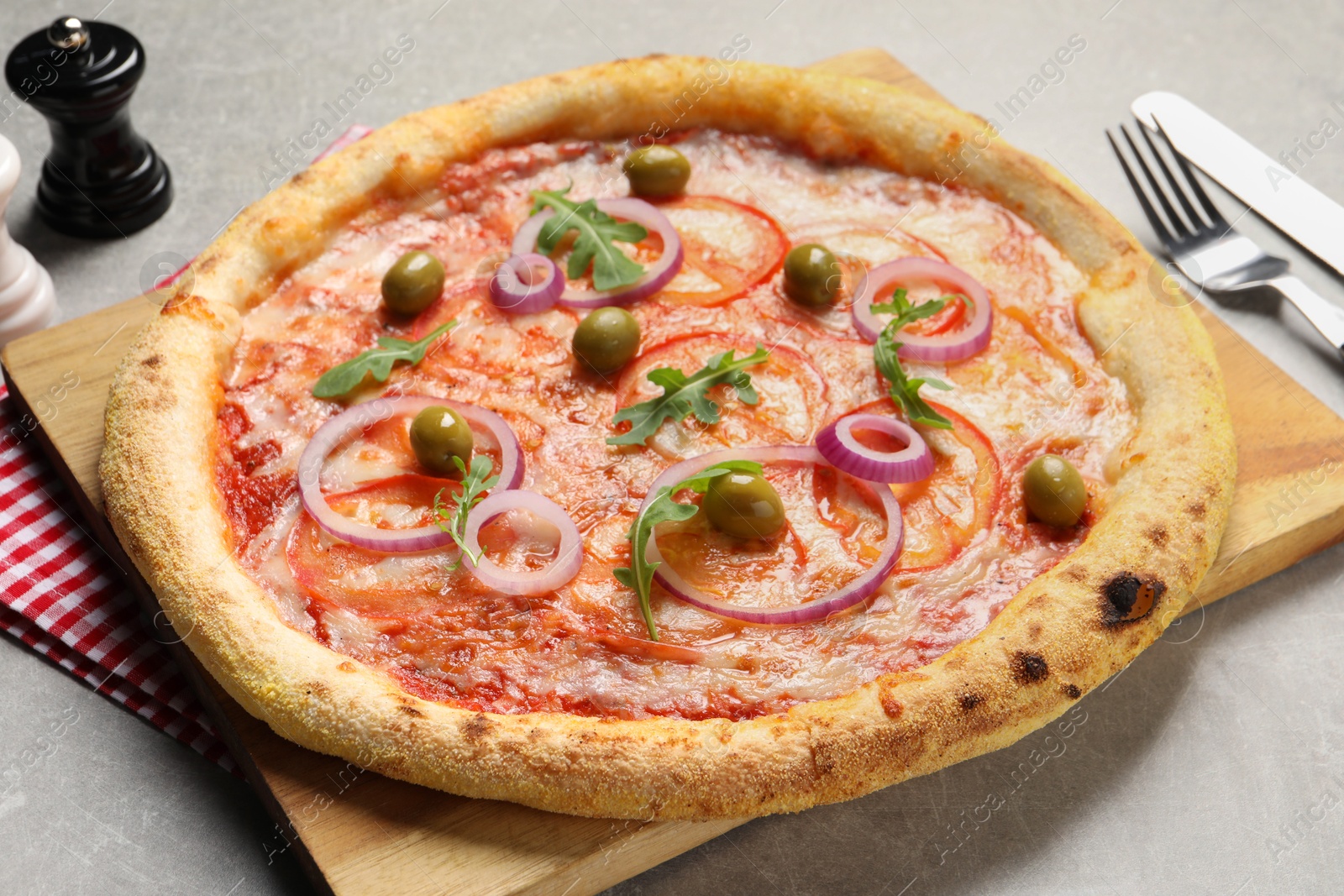 Photo of Delicious vegetarian pizza on light grey background, closeup