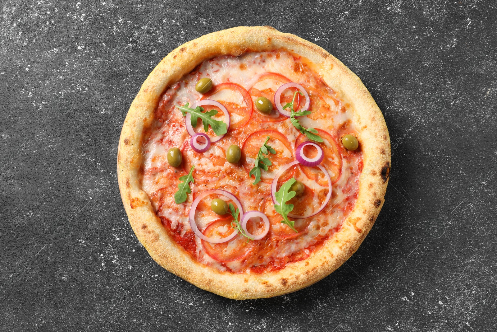 Photo of Delicious vegetarian pizza on black table, top view