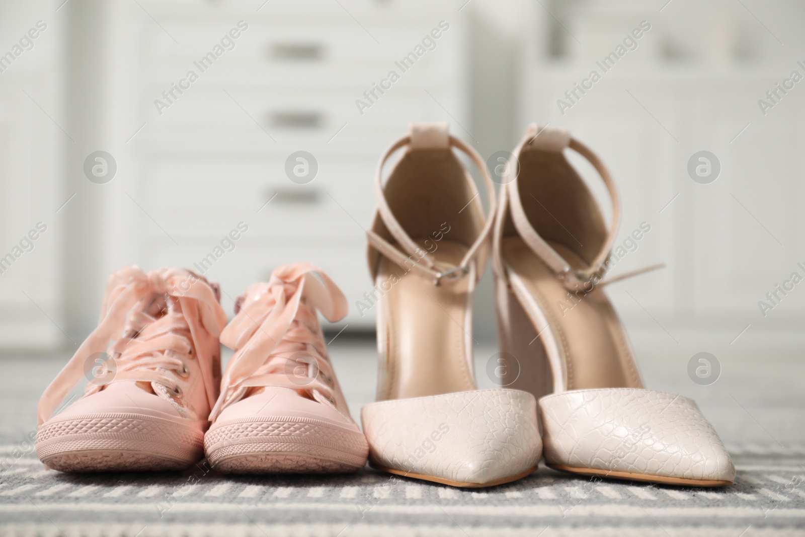 Photo of Big and small shoes on carpet indoors