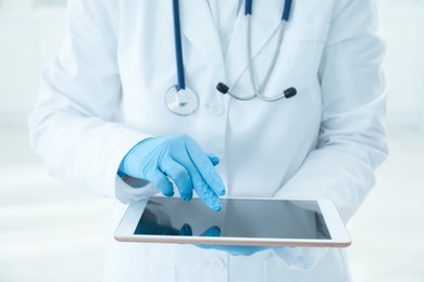 Photo of Doctor with tablet in clinic, closeup view