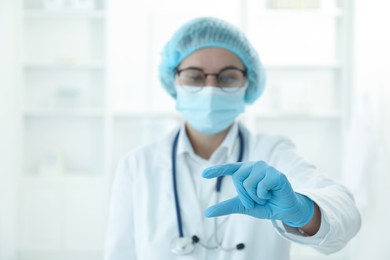 Doctor holding something in clinic, selective focus. Space for text