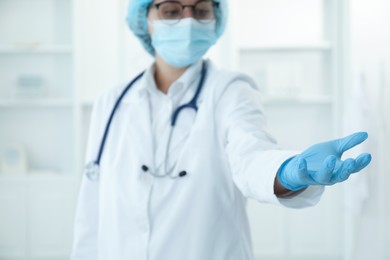 Doctor holding something in clinic, selective focus. Space for text