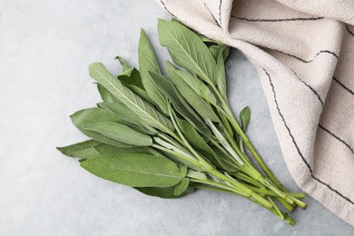 Photo of Fresh sage leaves on grey table, top view