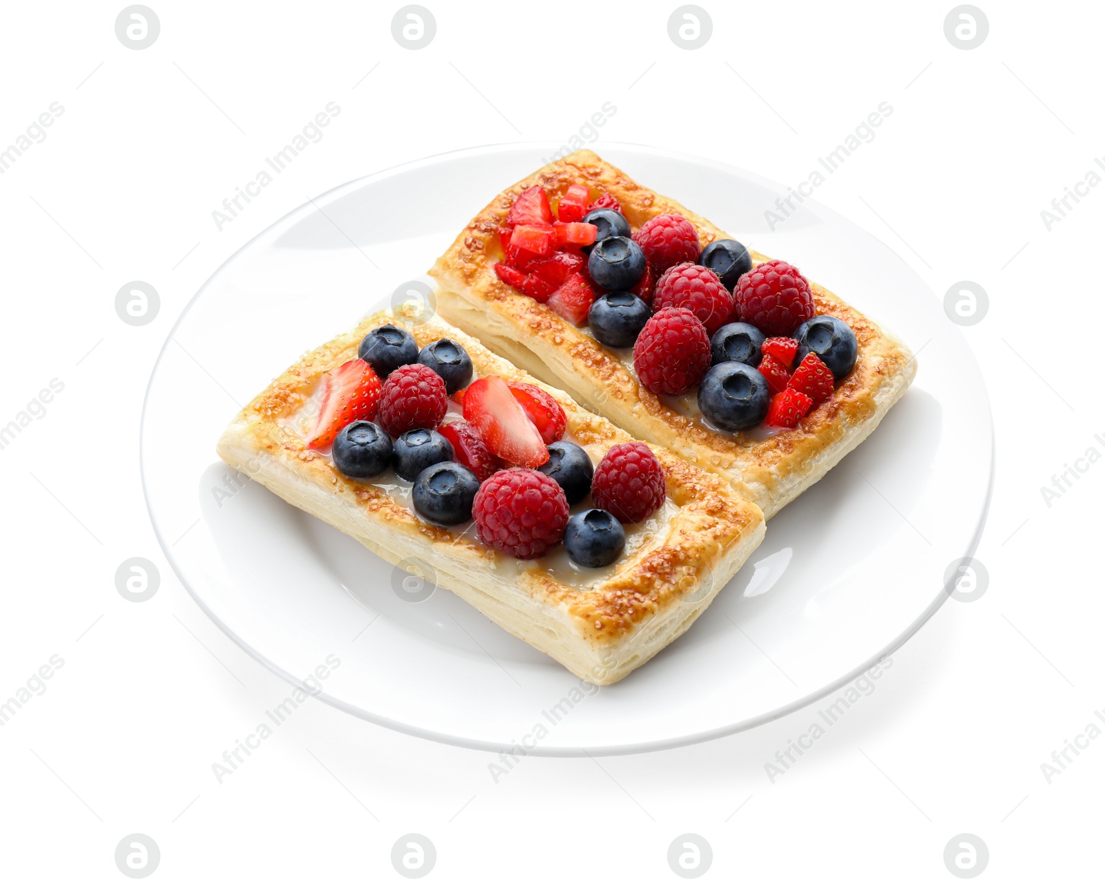 Photo of Tasty puff pastries with berries isolated on white