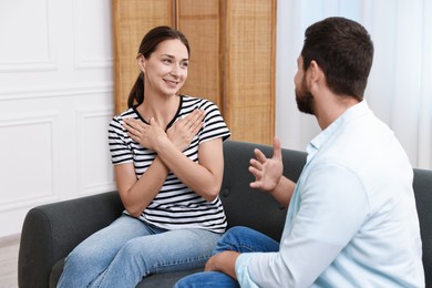 Man and woman using sign language for communication at home